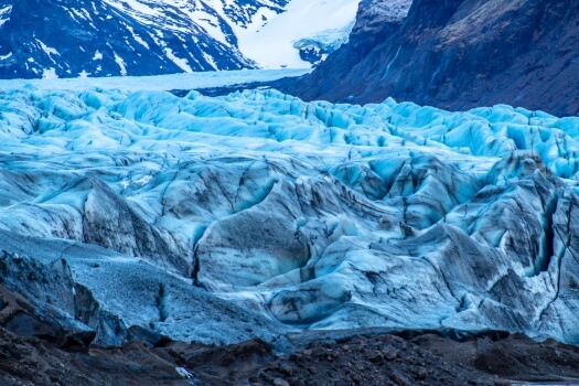 The edge of a glacier at the bottom of a mountain